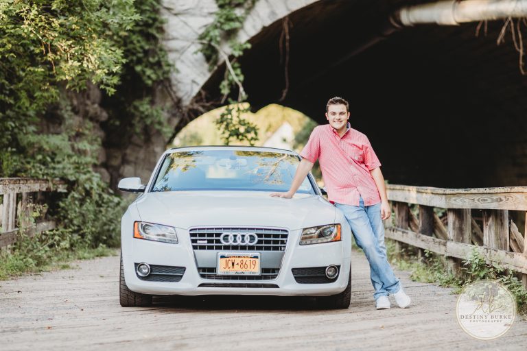 Senior posing with car at Corbett's Glen Park Penfield, NY
