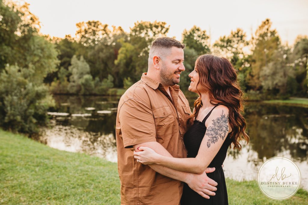 Family posing for family portrait photography session in Chili, NY at Black Creek Park near Rochester, NY