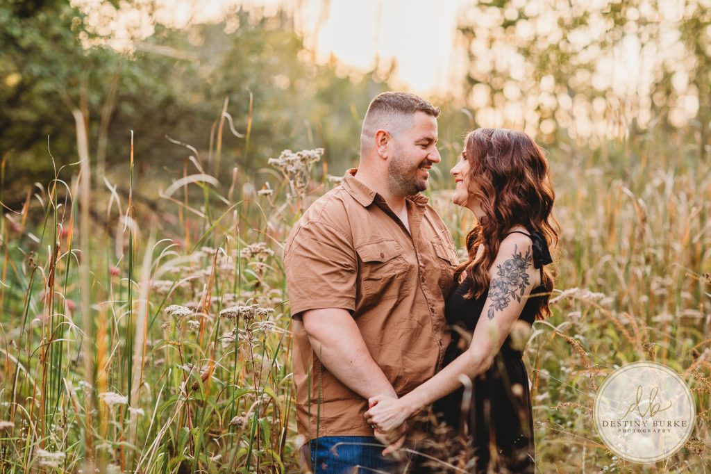 Family posing for family portrait photography session in Chili, NY at Black Creek Park near Rochester, NY