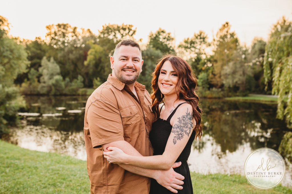 Family posing for family portrait photography session in Chili, NY at Black Creek Park near Rochester, NY
