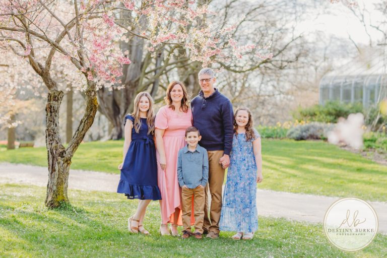 best family photographer near Rochester, NY, at Highland Park, family of 5 under the Cherry Blossom trees, photographed by Destiny Burke Photography at sunset.