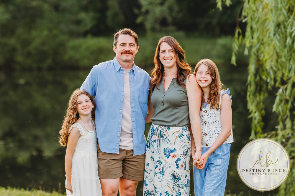 Generational family portrait of the Landry Family captured outdoors in Upstate NY with natural golden light and heartfelt connection, by Rochester photographer Destiny Burke.