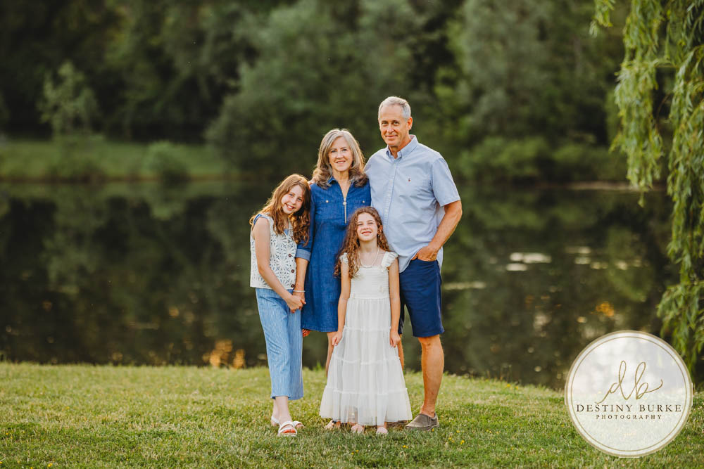 Generational family portrait of the Landry Family captured outdoors in Upstate NY with natural golden light and heartfelt connection, by Rochester photographer Destiny Burke.