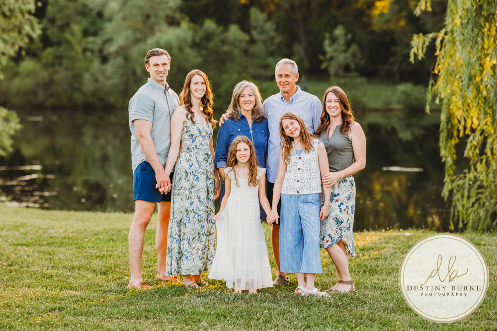 Generational family portrait of the Landry Family captured outdoors in Upstate NY with natural golden light and heartfelt connection, by Rochester photographer Destiny Burke.