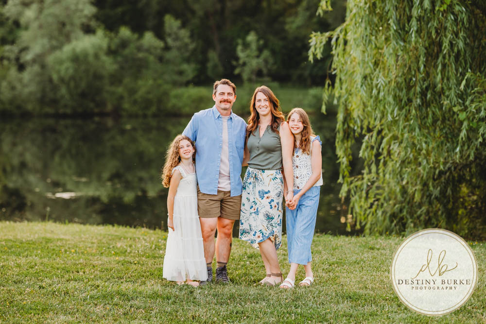 Generational family portrait of the Landry Family captured outdoors in Upstate NY with natural golden light and heartfelt connection, by Rochester photographer Destiny Burke.