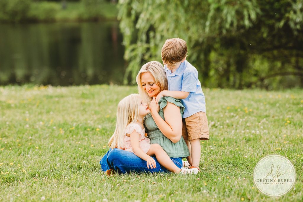 Extended family portrait of the Landry Family taken during golden hour in Rochester, NY. Captured by Destiny Burke Photography, featuring multiple generations with natural posing, warm light, and candid emotion.
