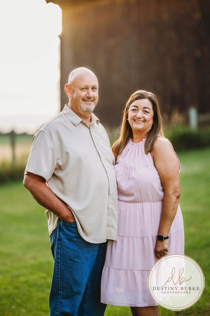 Golden hour extended family photo of the Carson/Ingersoll family in Caledonia, NY, featuring parents, grandparents, and their smiling young child. Captured by Destiny Burke Photography with warm light, candid emotion, and timeless connection.
