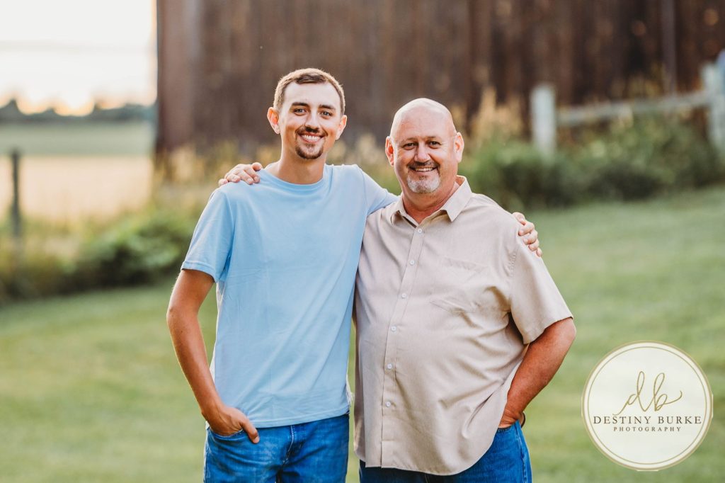 Golden hour extended family photo of the Carson/Ingersoll family in Caledonia, NY, featuring parents, grandparents, and their smiling young child. Captured by Destiny Burke Photography with warm light, candid emotion, and timeless connection.