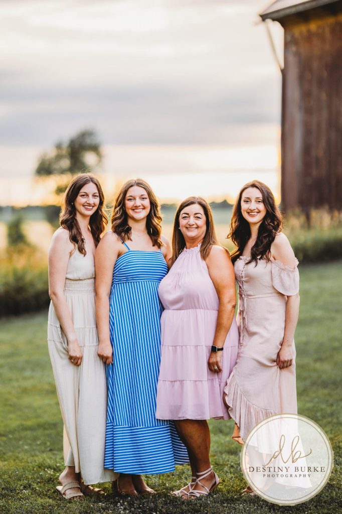 Golden hour extended family photo of the Carson/Ingersoll family in Caledonia, NY, featuring parents, grandparents, and their smiling young child. Captured by Destiny Burke Photography with warm light, candid emotion, and timeless connection.