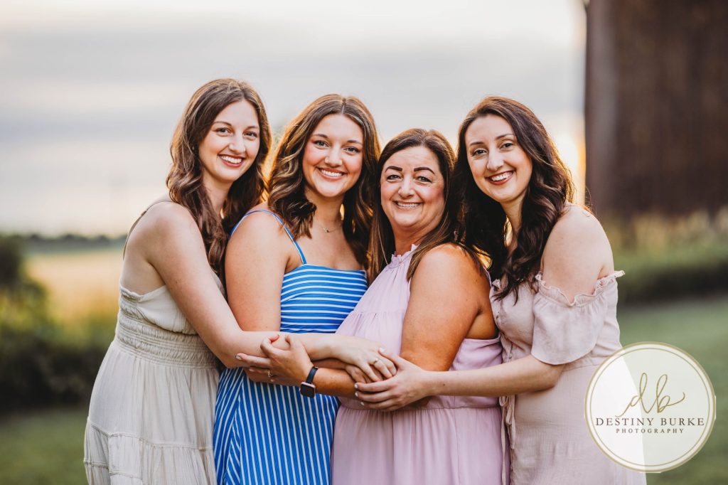 Golden hour extended family photo of the Carson/Ingersoll family in Caledonia, NY, featuring parents, grandparents, and their smiling young child. Captured by Destiny Burke Photography with warm light, candid emotion, and timeless connection.