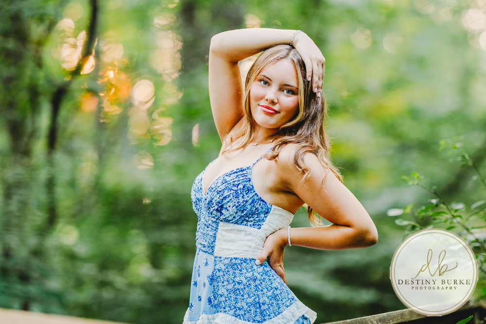 best Senior Portrait Photographer near Rochester, NY at Tinker Park with wildflowers at sunset golden hour