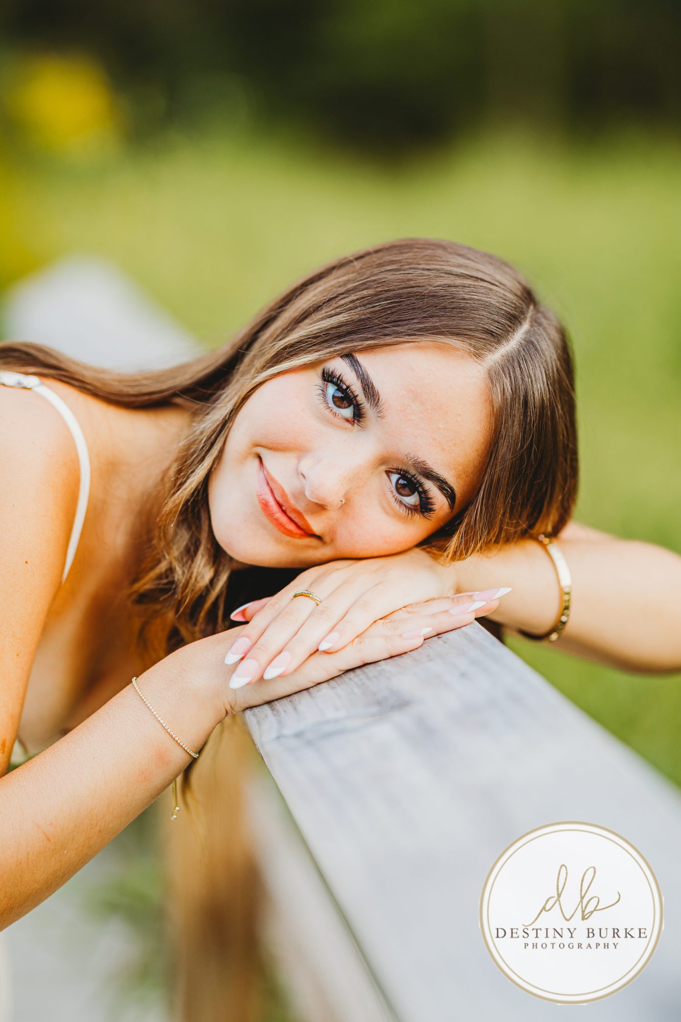 best Senior Portrait Photographer near Rochester, NY at Tinker Park with wildflowers at sunset golden hour