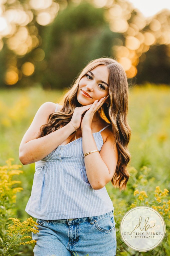 best Senior Portrait Photographer near Rochester, NY at Tinker Park with wildflowers at sunset golden hour