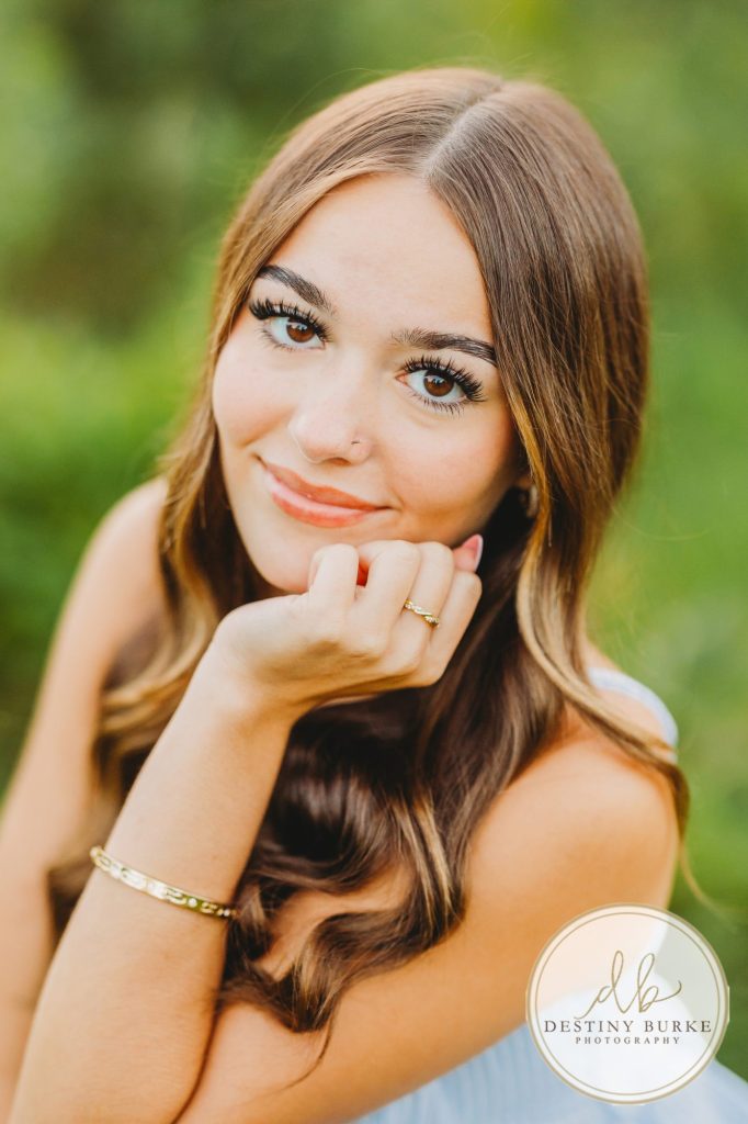 best Senior Portrait Photographer near Rochester, NY at Tinker Park with wildflowers at sunset golden hour