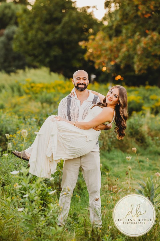 best Senior Portrait Photographer near Rochester, NY at Tinker Park with wildflowers at sunset golden hour