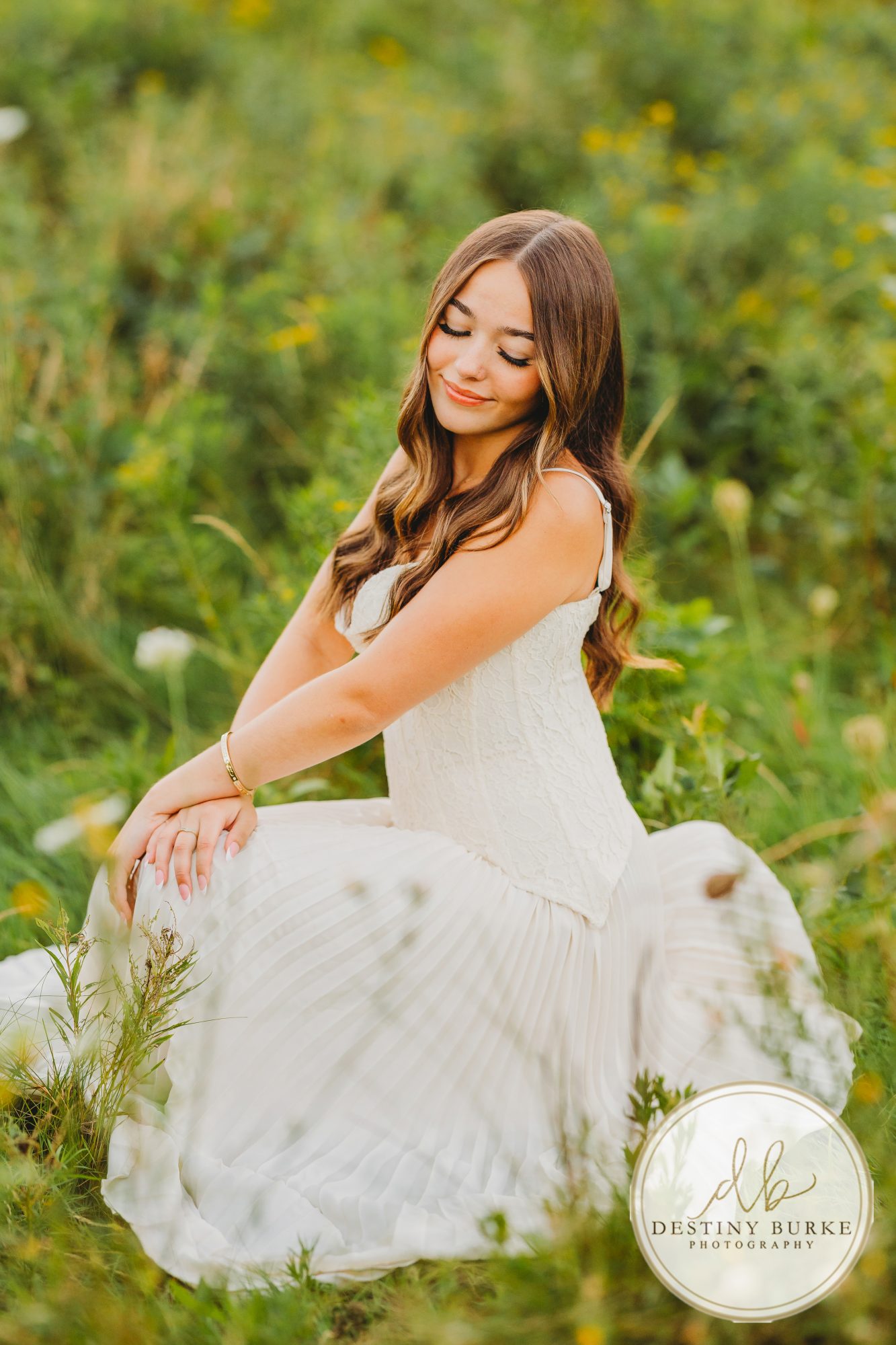 best Senior Portrait Photographer near Rochester, NY at Tinker Park with wildflowers at sunset golden hour